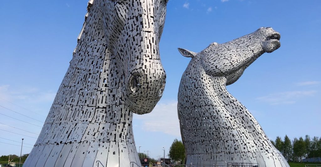 Stunning view of The Kelpies sculptures under a bright blue sky in summer.