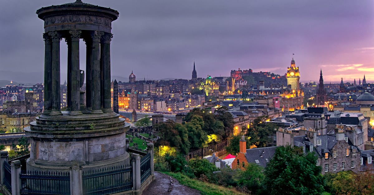 Stunning cityscape of Edinburgh at twilight from Calton Hill, showcasing landmarks and skyline.